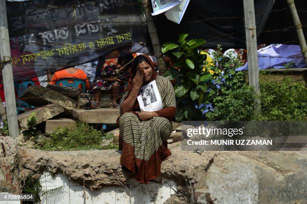 Bangladeshi relative of a victim of the Rana Plaza building collapse weeps as she marks the second anniversary of the disaster at the site where the...