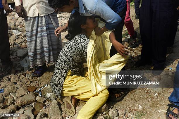 Bangladeshi relative of a victim of the Rana Plaza building collapse weeps as she marks the second anniversary of the disaster at the site where the...