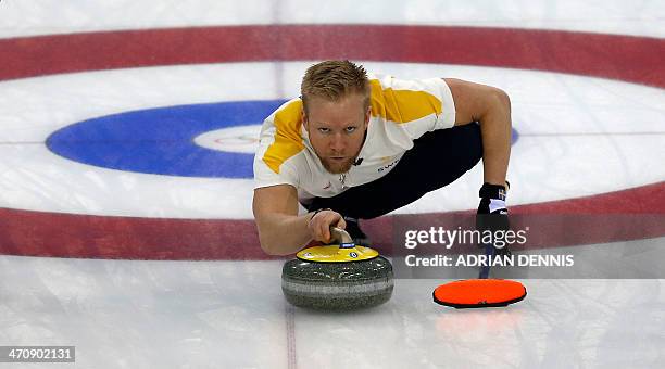 Sweden's Skip Niklas Edin throws a stone during the men's Bronze medal match between Sweden and China at the Ice Cube curling centre in Sochi on...