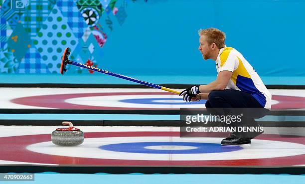 Sweden's Skip Niklas Edin lines up a throw during the men's Bronze medal match between Sweden and China at the Ice Cube curling centre in Sochi on...