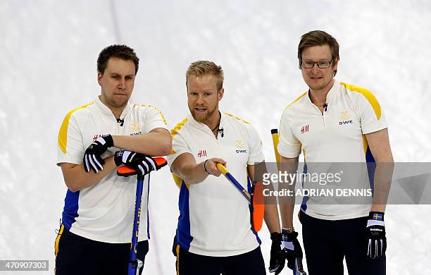 Sweden's Skip Niklas Edin discusses a throw with Viktor Kjaell and Fredrik Lindberg during the men's Bronze medal match between Sweden and China at...