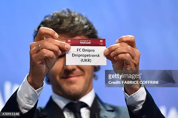 The ambassador for the UEFA Champions League final in Berlin Karl-Heinz Riedle shows the name of Dnipro Dnipropetrovsk during the draw for the UEFA...