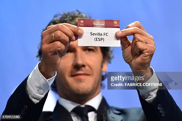 The ambassador for the UEFA Champions League final in Berlin Karl-Heinz Riedle shows the name of Sevilla during the draw for the UEFA Europa League...