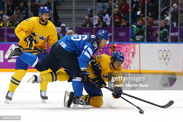 Alexander Steen of Sweden tries to shoot against Jussi Jokinen of Finland in the first period during the Men's Ice Hockey Semifinal Playoff on Day 14...