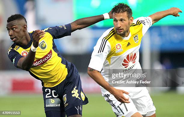 Bernie Ibini of the Mariners chases runs the ball against Vince Lia of the Phoenix during the round 20 A-League match between the Central Coast...