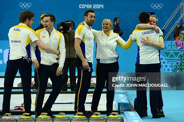 Sweden's Fredrik Lindberg and teammates celebrate after winning the men's Bronze medal match between Sweden and China at the Ice Cube curling centre...