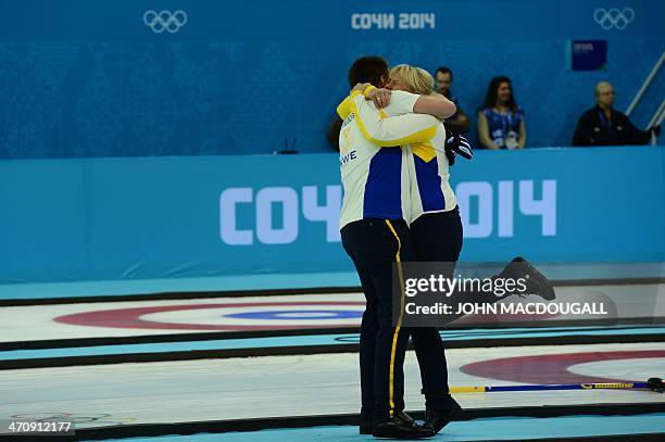 Sweden's coach Eva Lund celebrates with a player after winning the men's Bronze medal match between Sweden and China at the Ice Cube curling centre...