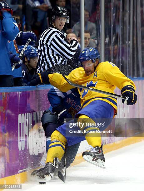 Daniel Alfredsson of Sweden collides with Mikael Granlund of Finland in the second period during the Men's Ice Hockey Semifinal Playoff on Day 14 of...