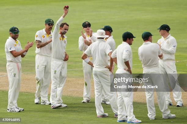 Australian players applaud their teammate Nathan Lyon after he took 5 wickets during day two of the Second Test match between South Africa and...