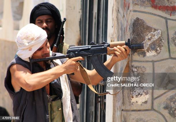 An armed militiaman loyal to Yemen's fugitive President Abderabbo Mansour Hadi keeps position during reported clashes with Huthi rebels in the port...