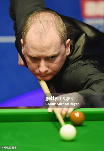 Graeme Dott of Scotland plays a shot against Stuart Bingham of England during day seven of the 2015 Betfred World Snooker Championship at Crucible...