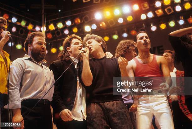 Concert Promoter Harvey Goldsmith,Bono of U2, Paul McCartney, Freddie Mercury of Queen performing on stage during the finale at Wembley Stadium....