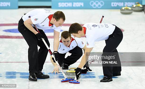 Great Britain's Scott Andrews and Michael Goodfellow brush the ice surface after Greg Drummond threw the stone during the Men's Curling Gold Medal...