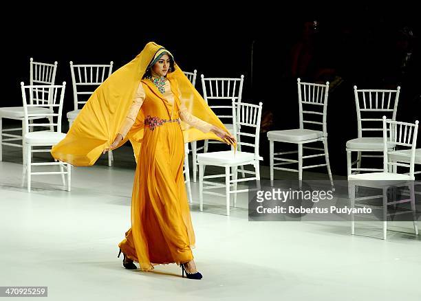Model showcases Shafira designs by Fenny Mustafa on the runway at The La Dolce Vita show during Indonesia Fashion Week 2014 day 2 at Jakarta...