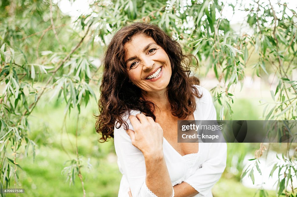 Beautiful mature woman outdoors in nature