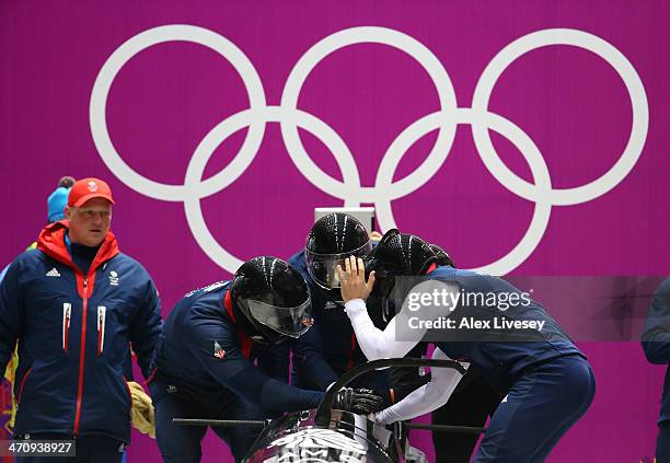 John Jackson, Stuart Benson, Bruce Tasker and Joel Fearon of Great Britain prepare to start during a four-man bobsleigh practice session on Day 14 of...