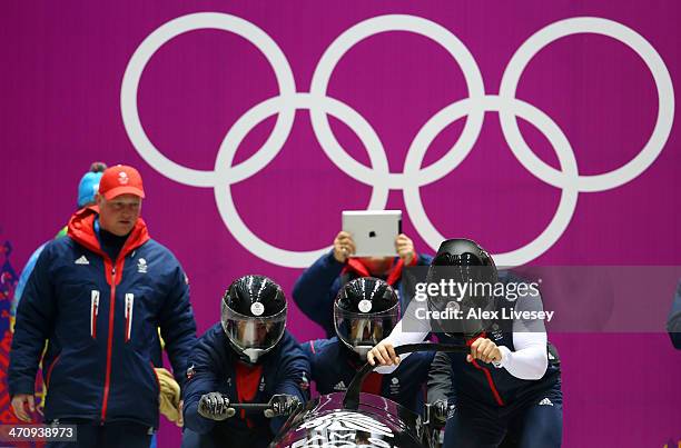 John Jackson, Stuart Benson, Bruce Tasker and Joel Fearon of Great Britain prepare to start during a four-man bobsleigh practice session on Day 14 of...