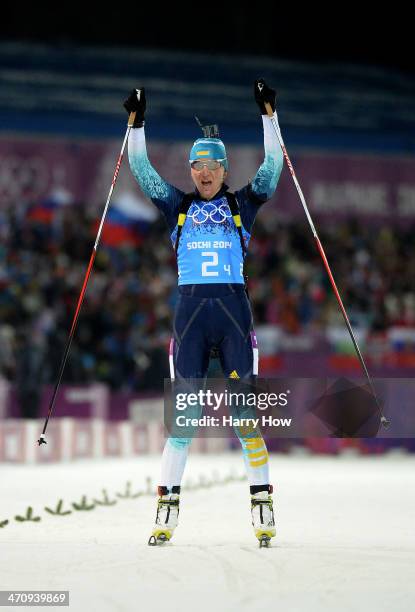 Gold medalist Olena Pidhrushna of Ukraine celebrates as she crosses the finish line to win the Women's 4 x 6 km Relay during day 14 of the Sochi 2014...