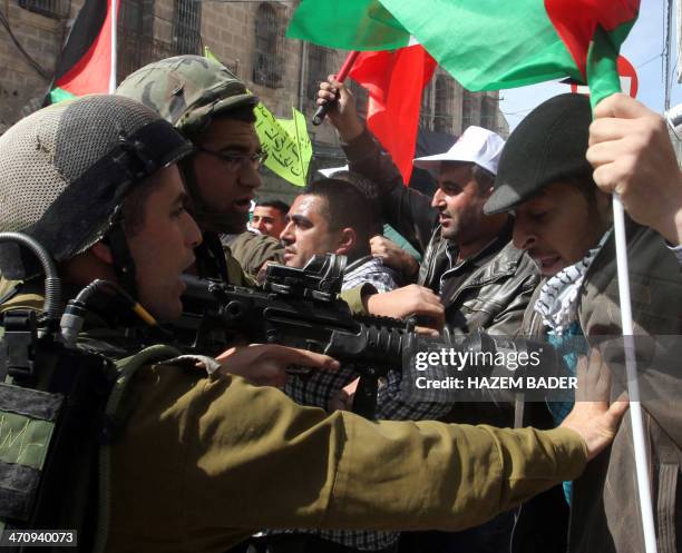 Israeli soldiers scuffle with a Palestinian protester in the center of the West Bank city of Hebron, on February 21, 2014 during a demonstration...