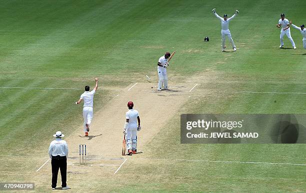 England's bowler James Anderson celebrates bowling out West Indies batsman Devon Smith during day four of the second Test cricket match between the...