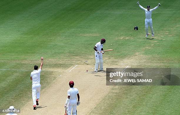 England's bowler James Anderson celebrates bowling out West Indies batsman Devon Smith during day four of the second Test cricket match between the...