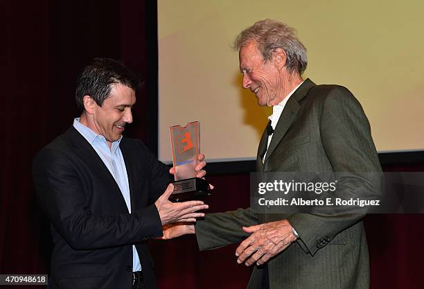 President of Fandango Paul Yanover presents Clint Eastwood with the Fan Choice award for Favorite Film of 2014, 'American Sniper,' onstage during...