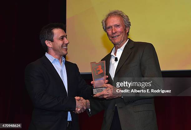 President of Fandango Paul Yanover presents Clint Eastwood with the Fan Choice award for Favorite Film of 2014, 'American Sniper,' onstage during...