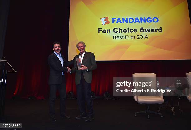 President of Fandango Paul Yanover presents Clint Eastwood with the Fan Choice award for Favorite Film of 2014, 'American Sniper,' onstage during...