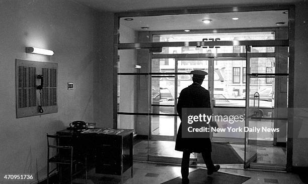 Doorman looks from lobby of W. 72d St. Apartment house where teacher Roseann Quinn was murdered.