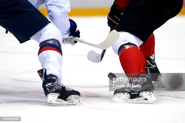 Jonathan Toews of Canada faces off against Joe Pavelski of the United States during the Men's Ice Hockey Semifinal Playoff on Day 14 of the 2014...