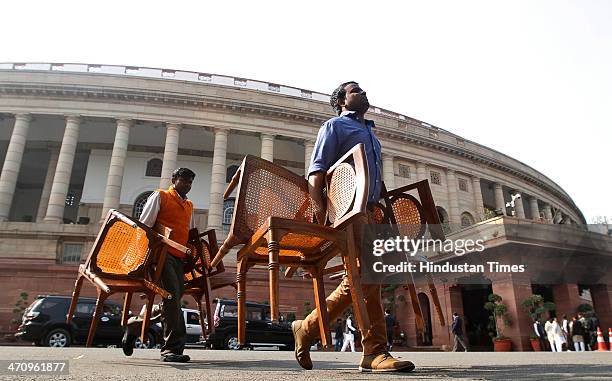 Parliament staff carrying out chairs from Parliament House on the last day of 15th Lok Sabha on February 21, 2014 in New Delhi, India. Rajya Sabha...