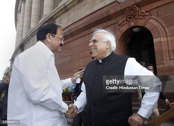 Union Minister Kapil Sibal and BJP MP M Venkaiah Naidu at Parliament House on the last day of 15th Lok Sabha on February 21, 2014 in New Delhi,...