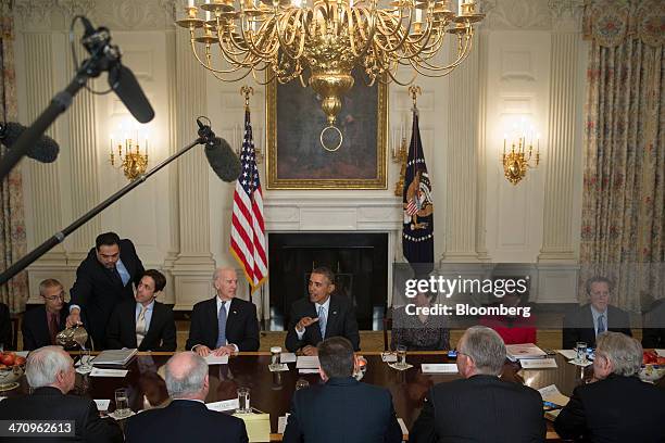 President Barack Obama, center, speaks while meeting with members of the Democratic Governors Association in the State Dining Room with John Podesta,...