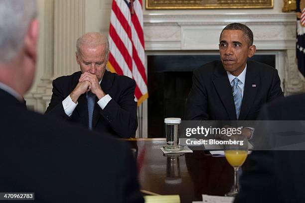 President Barack Obama, right, pauses while speaking during a meeting with members of the Democratic Governors Association in the State Dining Room...