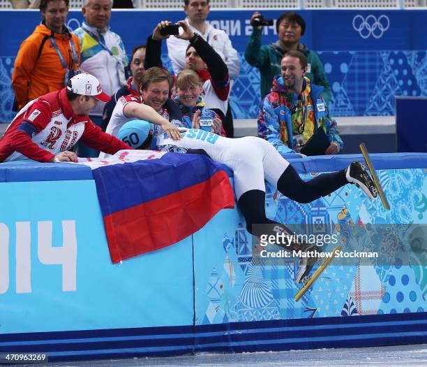 Victor An of Russia celebrates winning the gold medal with his coach in the Short Track Men's 500m Final A on day fourteen of the 2014 Sochi Winter...