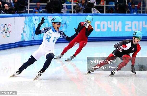 Victor An of Russia celebrates winning the gold medal in the Short Track Men's 500m Final A on day fourteen of the 2014 Sochi Winter Olympics at...