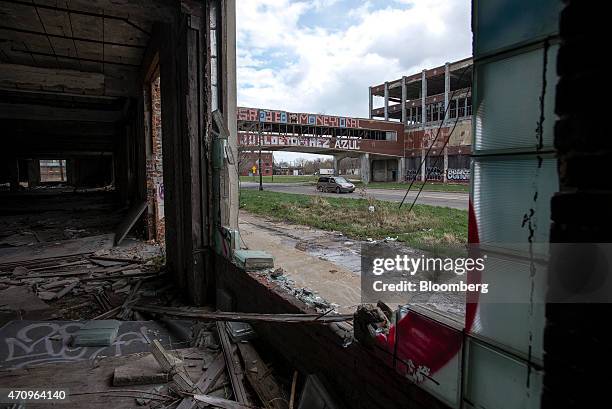 Van drives under the bridge that crosses East Grand Boulevard connecting sections of the abandoned Packard auto assembly plant in Detroit, Michigan,...