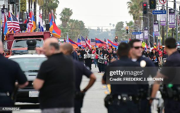 Under police escort, tens of thousands of protesters take to the streets of Los Angeles on April 24 to march for justice and in memory of victims of...