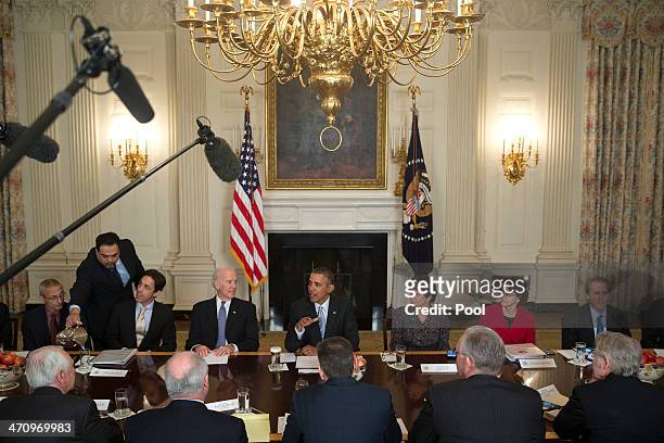 President Barack Obama, center, speaks while meeting with members of the Democratic Governors Association in the State Dining Room with John Podesta,...