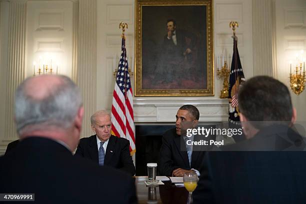 President Barack Obama, right, speaks while meeting with members of the Democratic Governors Association in the State Dining Room of the White House...