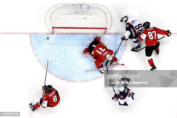 Carey Price of Canada makes a save against T.J. Oshie and Paul Stastny of the United States during the Men's Ice Hockey Semifinal Playoff on Day 14...