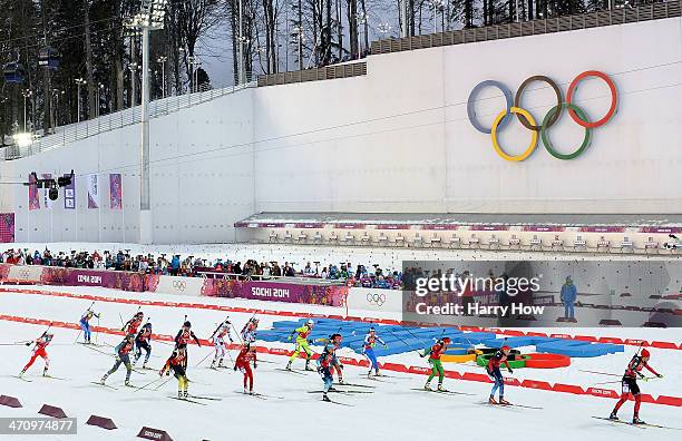 Athletes pass the Olympic Rings as they start the Women's 4 x 6 km Relay during day 14 of the Sochi 2014 Winter Olympics at Laura Cross-country Ski &...