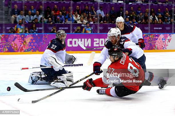 Sidney Crosby of Canada attempts to score against Brooks Orpik and Jonathan Quick of the United States during the Men's Ice Hockey Semifinal Playoff...
