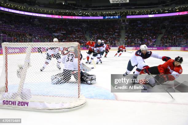 Brooks Orpik of the United States and Sidney Crosby of Canada fall to the ice during the Men's Ice Hockey Semifinal Playoff on Day 14 of the 2014...