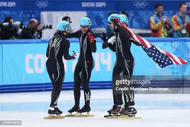 Members of the United States short track team celebrate winning the silver medal in the Short Track Men's 5000m Relay on day fourteen of the 2014...