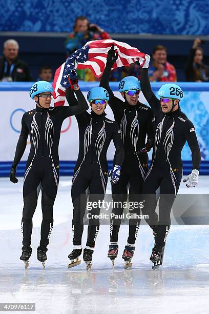 Members of the United States short track team celebrate winning the silver medal in the Short Track Men's 5000m Relay on day fourteen of the 2014...