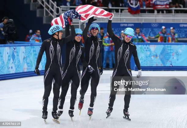 Members of the United States short track team celebrate winning the silver medal in the Short Track Men's 5000m Relay on day fourteen of the 2014...