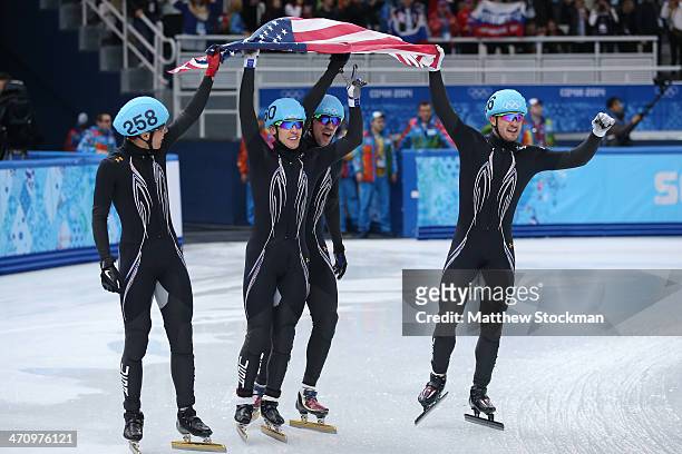 Members of the United States short track team celebrate winning the silver medal in the Short Track Men's 5000m Relay on day fourteen of the 2014...
