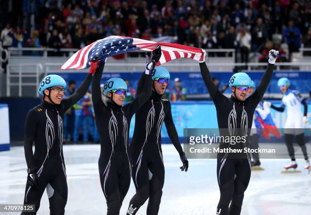 Members of the United States short track team celebrate winning the silver medal in the Short Track Men's 5000m Relay on day fourteen of the 2014...