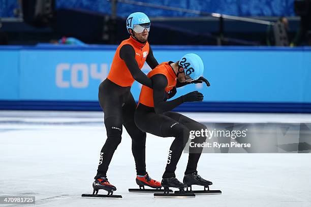 Niels Kerstholt of the Netherlands consoles teammate Daan Breeuwsma after in the Short Track Men's 5000m Relay on day fourteen of the 2014 Sochi...